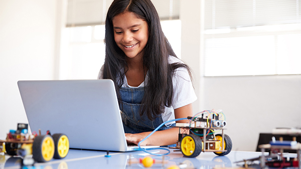 Robophysics education for High school, a girl coding with RoboPhone app and a robotic kit